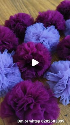 purple and blue flowers sitting on top of a wooden table