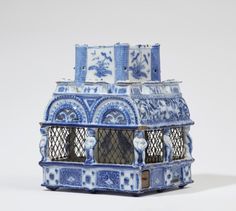 a blue and white birdcage sitting on top of a table