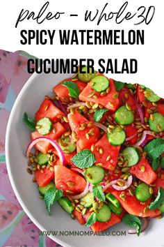 a white bowl filled with watermelon cucumber salad on top of a table