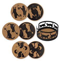 a set of four coasters with dogs and cats on them in black and brown