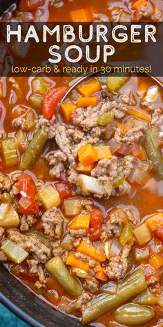 hamburger soup in a large pot with vegetables and meat on top, ready to be eaten