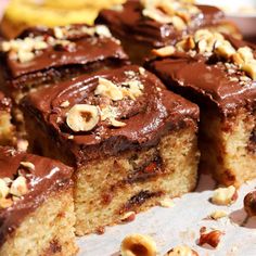 there are many pieces of cake with nuts on the top and one slice has chocolate frosting