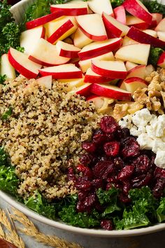 a salad with apples, cranberries, walnuts and feta cheese in it