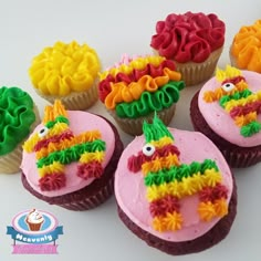 cupcakes decorated with colorful frosting and decorations