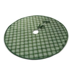 a green and white checkered round tablecloth with an empty hole in the center