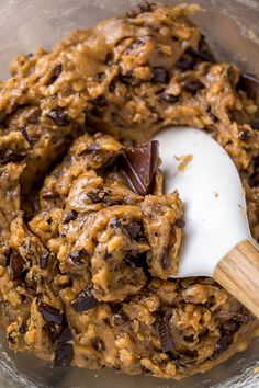 chocolate chip cookie dough in a bowl with a wooden spoon