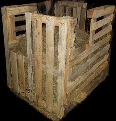 a horse is standing inside of a wooden stall with hay in it's back