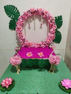 a pink bench decorated with flowers and leaves in front of a mirror on the wall