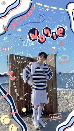 a man standing in front of a wooden fence on top of a beach next to the ocean