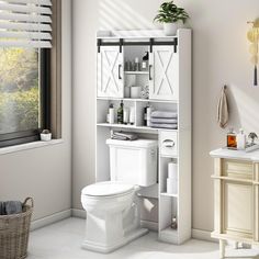 a white toilet sitting next to a sink in a bathroom under a window with blinds