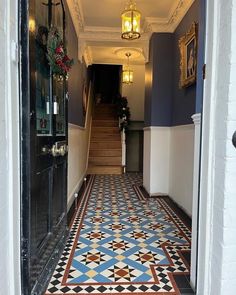 the hallway is decorated with colorful tiles and gold accents, along with ornate doorways