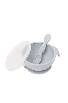 a bowl with a toothbrush in it and a lid on the bottom that is empty