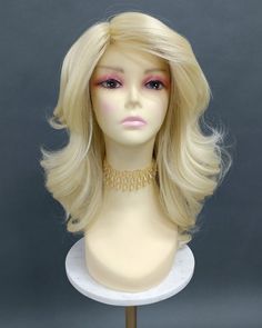 "Synthetic wig featuring thick, slightly texturized (for volume) heat-safe fibers along with a partial skin top. Mostly straight with glamorous loose waves. Inside cap has adjustable elastic straps, no combs or clips. Heat-resistant at 350F. Color: Light Blonde (613) Length: 18 Inches Circumference: 21\" with adjustable cap (max 22\") Materials: Heat Resistant Synthetic Wig Fiber All sales are final. Please read all store policies before purchasing." Curly Iron, Crystal Hair Band, Puffy Hair, Caramel Blonde, Bob Lace Front Wigs, Star Headband, Blonde Bombshell, Light Blonde, Blonde Wig