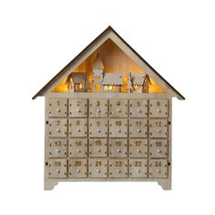 a wooden toy house with lots of drawers and lights in the top half, on a white background