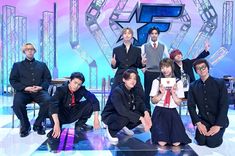 a group of young men and women posing for a photo in front of a stage