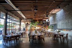 the inside of a restaurant with tables and chairs set up for an event or gathering