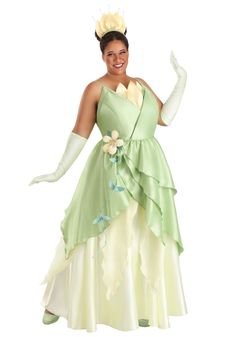 a woman in a green dress and white gloves posing for the camera with her arms outstretched