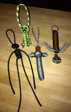 four different types of lanyards on a wooden floor with one tied up and the other knoted