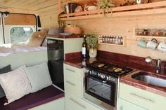 a kitchen with a stove top oven sitting next to a sink and countertop under a window