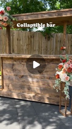 an outdoor bar made out of pallets with flowers and greenery on the top