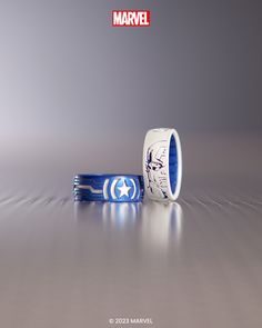 two wedding bands with captain america designs on them, one is blue and the other is white