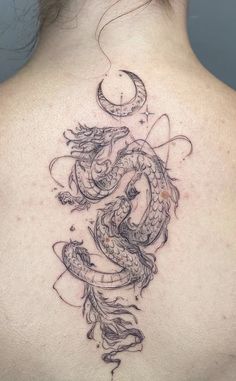 a woman with a dragon tattoo on her back