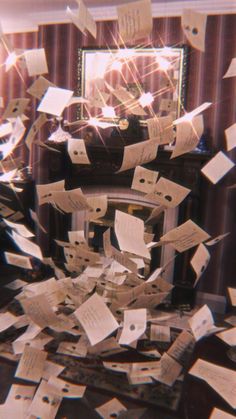 many pieces of paper are scattered on the floor in front of a mirror and chair