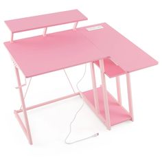 a pink computer desk with an electrical cord plugged into the top and underneath it