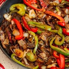 a skillet filled with beef and peppers