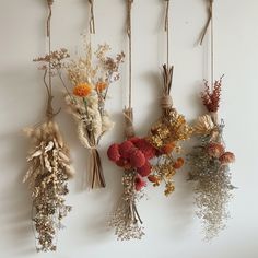 dried flowers hanging on the wall with twine