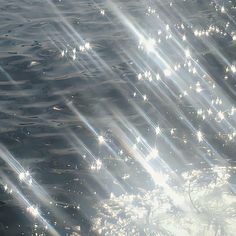 the sun shines brightly in the water as it reflects on the surface with ripples