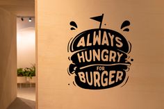 there is a sticker that says always hungry for burgers on the side of a wall