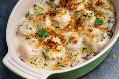 a green casserole dish filled with chicken and cheese