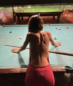 a person standing in front of a pool table