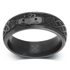 a black ring with an image of a frog and cross on the inside of it