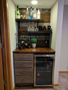 an empty bar with bottles and glasses on it