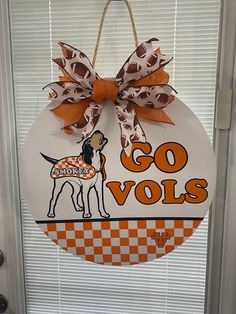 an orange and white door hanger with a dog on it