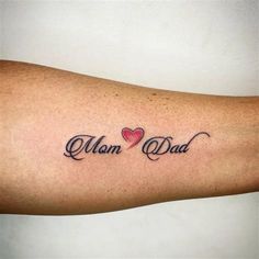 a man with a heart tattoo on his arm that says,'mom and dad '