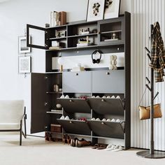 a living room with a book shelf filled with lots of shoes and other things on the floor