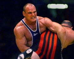 two wrestlers are wrestling in an arena