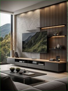 a living room with a large flat screen tv mounted on the wall next to a coffee table