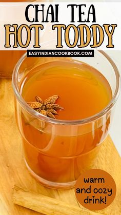 a cup of hot toddy tea sitting on top of a wooden cutting board