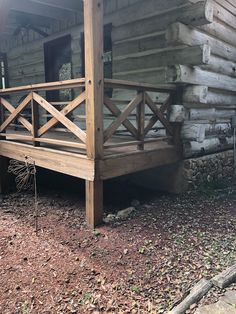 a wooden cabin with stairs leading up to the porch