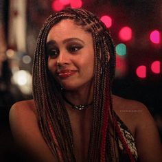 a close up of a person with long dreadlocks on their head and red lipstick