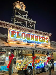 a truck parked in front of a building with a sign that says flounders