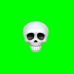 a white skull with black eyes on a green screen, in front of the camera