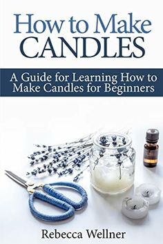 a book cover with scissors and other crafting supplies on the table, including candles