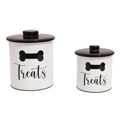 two black and white canisters with dogs'treats on the top one has a bone in it