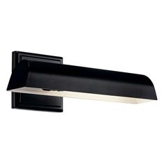 a black wall light with white trim on the top and bottom part of it's arm