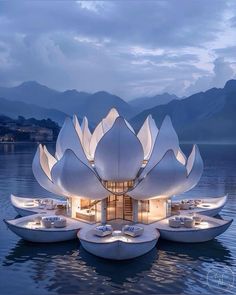 the floating house is designed to look like a waterlily lotus flower with lights on it's petals